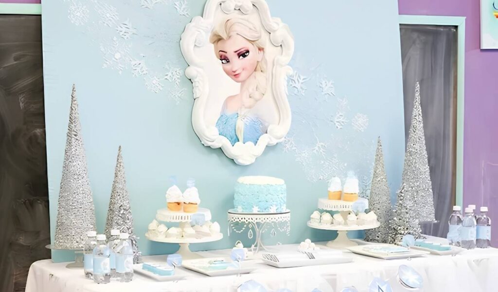 Frozen themed dessert table with birthday cake cupcakes snowflake decorations and fairy lights
