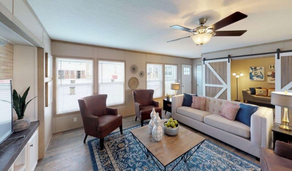 Mobile home living room layout with compact sofa, area rug, and clear traffic flow for a small space