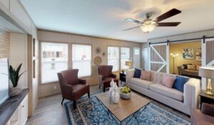 Mobile home living room layout with compact sofa, area rug, and clear traffic flow for a small space